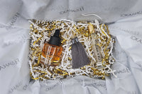 LOKA.HAUS beauty: 'Duality Oil' in amber, center 'Intensity Parfum Roller', & luxe tassel earrings on right. Elegance in a subscription box.