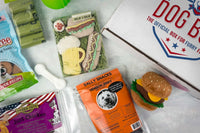 Variety of dog treats (bones and dehydrated fish/meat). Also includes teething toy, hamburger toy, and potty accessories. 
