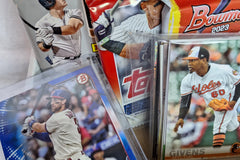 Our newer monthly subscription boxes feature three packs of cards, one special print card, and a repack.