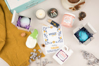 Hygge Mood Bath Bevy Subscription box with bath bombs, whipped soap scrub, candle, matches, and bubble bath jug