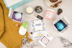 Hygge Mood Bath Bevy Subscription box with bath bombs, whipped soap scrub, candle, matches, and bubble bath jug