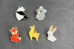 Love animals? Love origami? Look no further. These pins are your lovable critters (panda, fox, koala, but in origami form! 