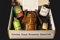 This shows the all of the contents of the suffering bastard inside of the open Swizzle Box box, laid out in a fun display.