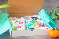 open snack box featuring products such as the good bean fava beans, off the eaten path, lesser evil popcorn