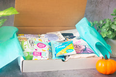 open snack box featuring products such as the good bean fava beans, off the eaten path, lesser evil popcorn