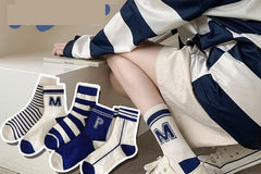 Athletic socks in a refreshing blue and white color combination, for October's box with sport style 