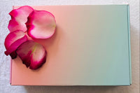 closed subscription box with rose petals as decoration