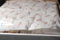 A Luxury Bath and Body Box with feathers on it, brand name Lavish.