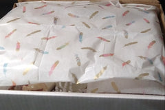 A Luxury Bath and Body Box with feathers on it, brand name Lavish.