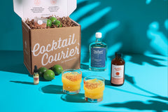 Image of the Mango Tango Margarita Cocktail Kit with Libelula Tequila, fresh limes, mango syrup, and bitters. 