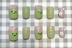 Set: Hop into Spring. Pink and green frog nails. Pink and white flower charms. green gingham on index and ring. frog on thumb and middle