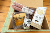 Truffle Pairings Tapas Box, including Fuet Dry Cured Sausage, Truffle Crackers, Salted Pistachios with Truffle and Spanish Aged Cheese.