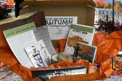 Box theme is autumn adventures, included newsletter, smores themed lip balm holder with lip balm, a fall sented candle in a tin and Tossits 