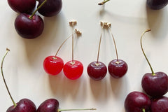 Colorful assortment of unique earrings including food and whimsical designs in the Monthly Earring Mania subscription box