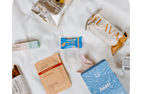 A birds-eye view of various products such as menstrual products, wellness products, and packages of biscotti and baklava. 