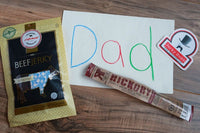 Aufschnitt's Original Jerky, a Righteous Felon OG Hickory stick, Jerky Snob sticker, and a child's handwriting of Dad, for Father's Day.