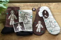 Funny playful Voodoo doll socks.  A surprisingly popular sock.  Two color variations available in maroon and ivory.