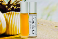 Two bottles of the Multi-tasker Eye Serum by Greenmade goods. Left showcases the golden hue of the serum. Right shows the bottle with label.