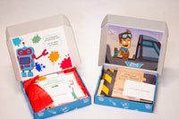 Open boxes of Doughbot's Creation Lab and Jet and Penny's Flight school showcasing the different elements inside each kit.