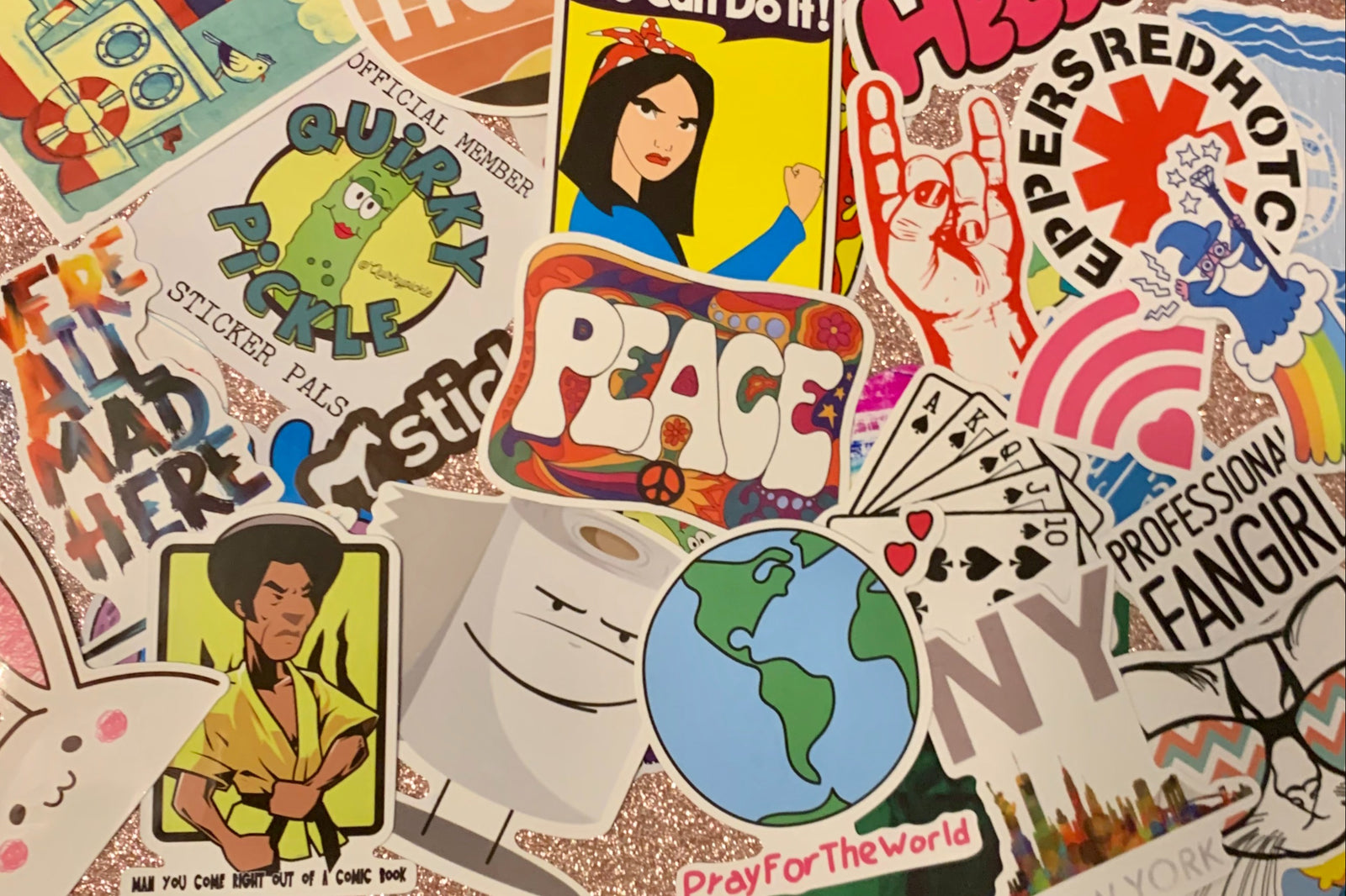 Pic shows assortment of stickers as an example of what can come in a Quirky Pickle pack. Stickers for packs are selected based on age range.