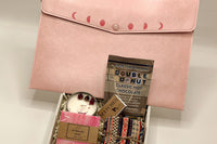 A moon phase rose quartz bag with hot chocolate to make a hot mug, while reading a book or enjoying company. 