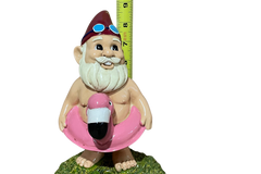 Gnome of the Month Club subscription box displayed on a front porch surrounded by neatly trimmed bushes