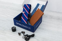 A SprezzaBox monthly subscription box featuring a watch, tie, socks, and a wooden comb for men's accessories