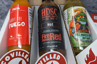 SCOVILLED subscription box featuring FAIYA What the Fuego, High Desert Sauce Co. Fire Roasted Red, and Mikey V's Dill Pickle Reaper