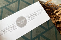Small letterpress notebook from the December 2023 box, featuring Masters of Atlantis by Charles Portis.