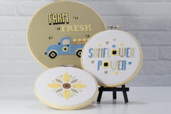 set of 3 cross stitch patterns with sunflowers theme, blue pickup filled with hearts and bees with embroidery hoop