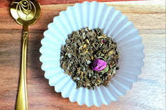A shot of my Cramp Reliever tea in loose leaf form in the center and one of our golden spoons on the left.