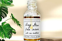 The Day Glow Serum by Greenmade goods. A bottle with golden serum dripping down over the label. Monstera plant in the background.
