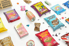 Angled image of the showcase box for FROD, in reality the most beautiful snacks we've found so far. Look at the cute little peach soda.