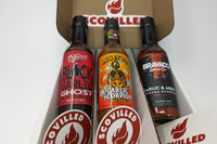 SCOVILLED hot sauce of the month club featuring Cajohn's Black Garlic Ghost, Mikey V's Garlic Scorpion, and Bravado Garlic & Arbol hot sauce