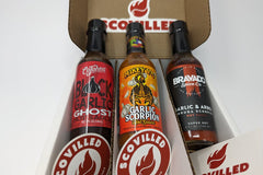 SCOVILLED hot sauce of the month club featuring Cajohn's Black Garlic Ghost, Mikey V's Garlic Scorpion, and Bravado Garlic & Arbol hot sauce