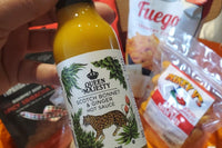 close up of queen majesty hot sauce and other spicy products included in our Hot Stuff subscription gift boxes.