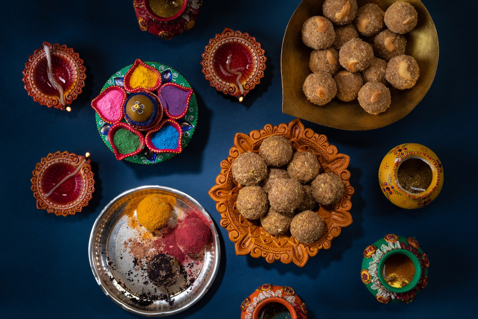 Colorful and ornate dishes are filled with exotic, artisan Indian sweets called Laddu.