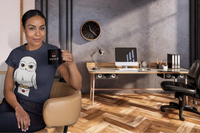 A lady taking a coffee break in an office. She is wearing a Harry Potter Hedwig Owl carrying a Hogwarts Letter Thsirt.