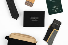 A SprezzaBox monthly subscription box featuring a watch, tie, socks, and a wooden comb for men's accessories