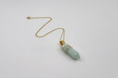 Elegant gold-plated gemstone necklace by LOKA.HAUS, laying flat on surface. Sustainable fashion, ethical luxury for social impact.