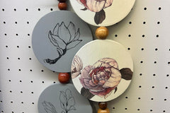 Wall hangings that are hand painted and beaded by one of our artisans. These also work great in tiered trays. 
