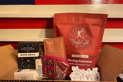 A date deck conversation starters, coin purse, flower sticker, clay eye mask, hand poured chap stick, necklace (on the coffee), and coffee!