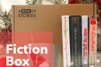 Brown subscription box filled with four surprise fiction books, offering captivating stories and diverse plots for literature lovers.