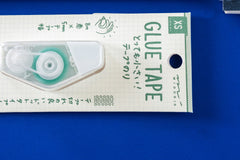 Close-up picture of notebook, pencils, stickers, pen, eraser, and business card. These items are an example of what may be included.