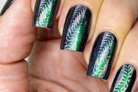 Nails with stamping nail art. Green nails with stripe of holographic silver polish down the middle and green foilage stamped.