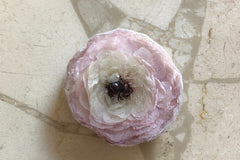 We hand make magnets that are made with whole preserved flowers cast in resin. The one featured in the image are of a preserved Ranunculus.