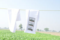 Baby Yoda Dish Towels that are blowing in the wind as they dry on a clothes line on a beautiful sunny day.