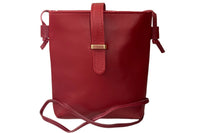 Red faux leather crossbody bag with zipper closure, buckle closure and adjustable straps.  Perfect for phone, wallet and keys.