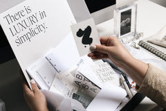 a past subscription box with planning, stationery, and pen items displayed.  The right hand is holding a journaling card.