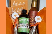 Spicy margarita mix, hot sauce, sweet and spicy lollipops and koozies in a box. These are some of the items in our mini gift boxes. 